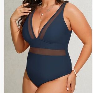Navy size M/L one piece women’s swimsuit.  Gorgeous plunging V neckline. NWT